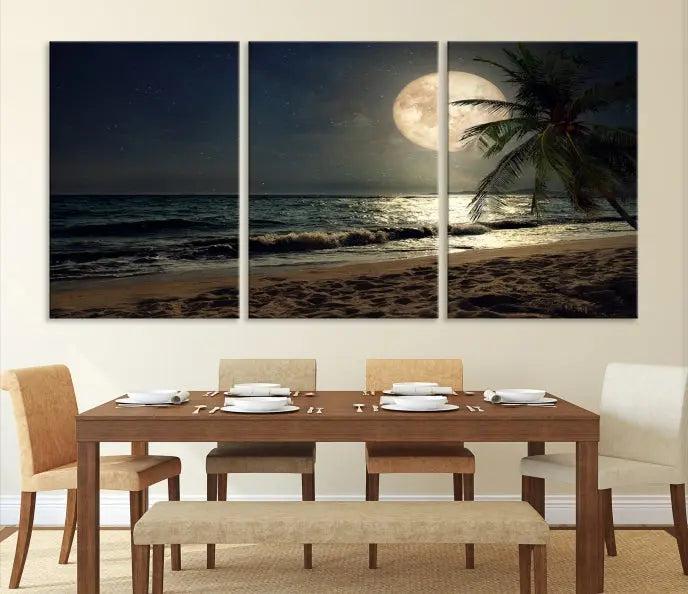 The Tropical Beach and Moon Wall Art Canvas Print features a stunning three-panel artwork of a moonlit beach, complete with waves and a palm tree beneath a starry night sky. It is displayed on museum-quality canvas with an elegant gallery wrap and includes a UV-protective coating for enduring beauty.