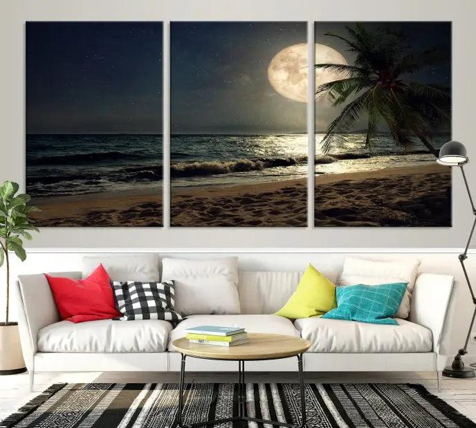 The Tropical Beach and Moon Wall Art Canvas Print features a stunning three-panel artwork of a moonlit beach, complete with waves and a palm tree beneath a starry night sky. It is displayed on museum-quality canvas with an elegant gallery wrap and includes a UV-protective coating for enduring beauty.