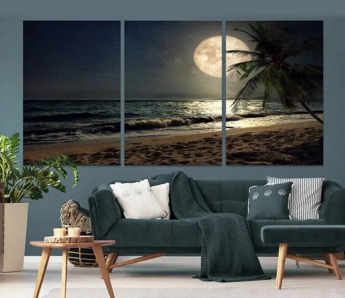 The Tropical Beach and Moon Wall Art Canvas Print features a stunning three-panel artwork of a moonlit beach, complete with waves and a palm tree beneath a starry night sky. It is displayed on museum-quality canvas with an elegant gallery wrap and includes a UV-protective coating for enduring beauty.