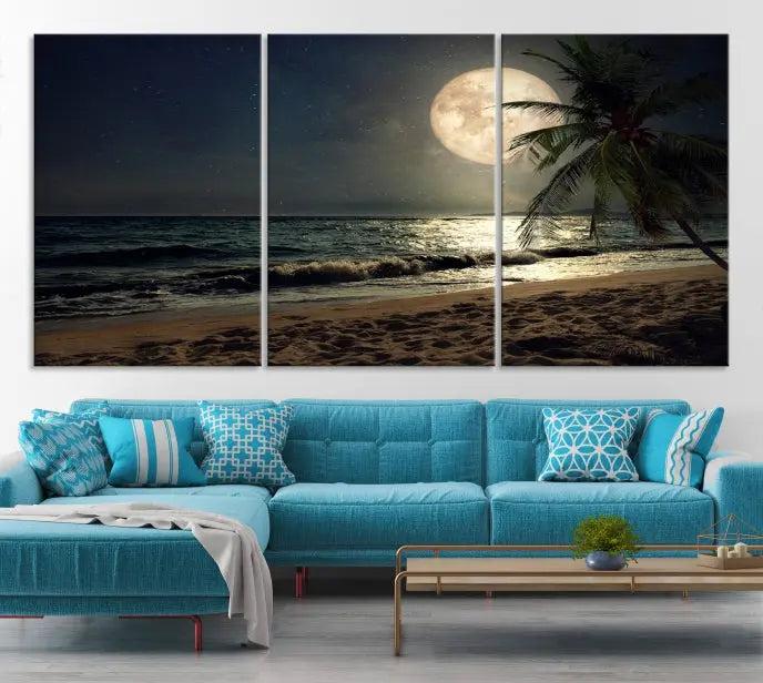 The Tropical Beach and Moon Wall Art Canvas Print features a stunning three-panel artwork of a moonlit beach, complete with waves and a palm tree beneath a starry night sky. It is displayed on museum-quality canvas with an elegant gallery wrap and includes a UV-protective coating for enduring beauty.