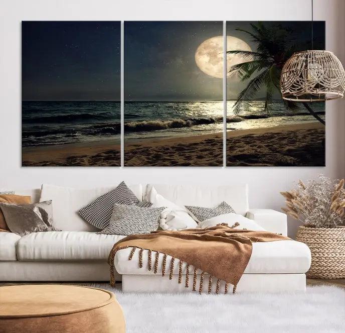 The Tropical Beach and Moon Wall Art Canvas Print features a stunning three-panel artwork of a moonlit beach, complete with waves and a palm tree beneath a starry night sky. It is displayed on museum-quality canvas with an elegant gallery wrap and includes a UV-protective coating for enduring beauty.