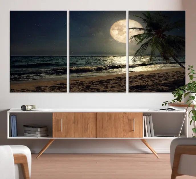 The Tropical Beach and Moon Wall Art Canvas Print features a stunning three-panel artwork of a moonlit beach, complete with waves and a palm tree beneath a starry night sky. It is displayed on museum-quality canvas with an elegant gallery wrap and includes a UV-protective coating for enduring beauty.