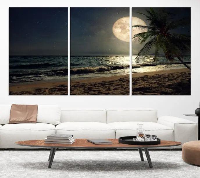 The Tropical Beach and Moon Wall Art Canvas Print features a stunning three-panel artwork of a moonlit beach, complete with waves and a palm tree beneath a starry night sky. It is displayed on museum-quality canvas with an elegant gallery wrap and includes a UV-protective coating for enduring beauty.