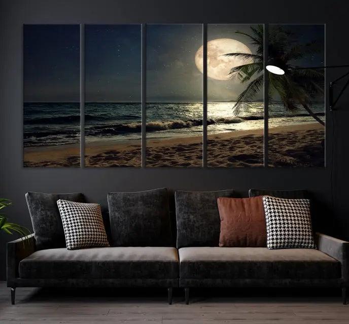 The Tropical Beach and Moon Wall Art Canvas Print features a stunning three-panel artwork of a moonlit beach, complete with waves and a palm tree beneath a starry night sky. It is displayed on museum-quality canvas with an elegant gallery wrap and includes a UV-protective coating for enduring beauty.