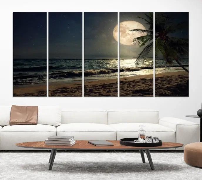 The Tropical Beach and Moon Wall Art Canvas Print features a stunning three-panel artwork of a moonlit beach, complete with waves and a palm tree beneath a starry night sky. It is displayed on museum-quality canvas with an elegant gallery wrap and includes a UV-protective coating for enduring beauty.