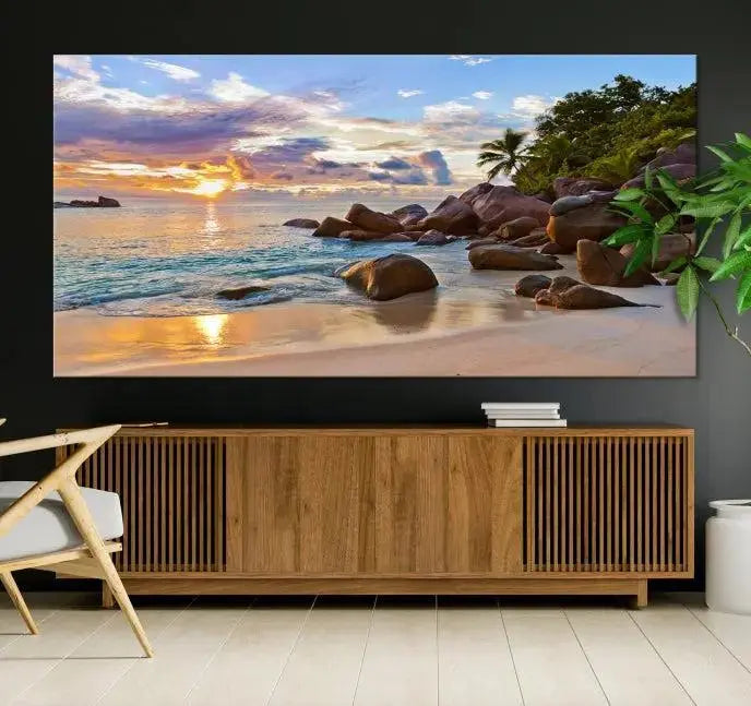 In a cozy living room, the "Tropical Island Beach Sunset Canvas Print," crafted on museum-quality canvas, hangs on the wall.