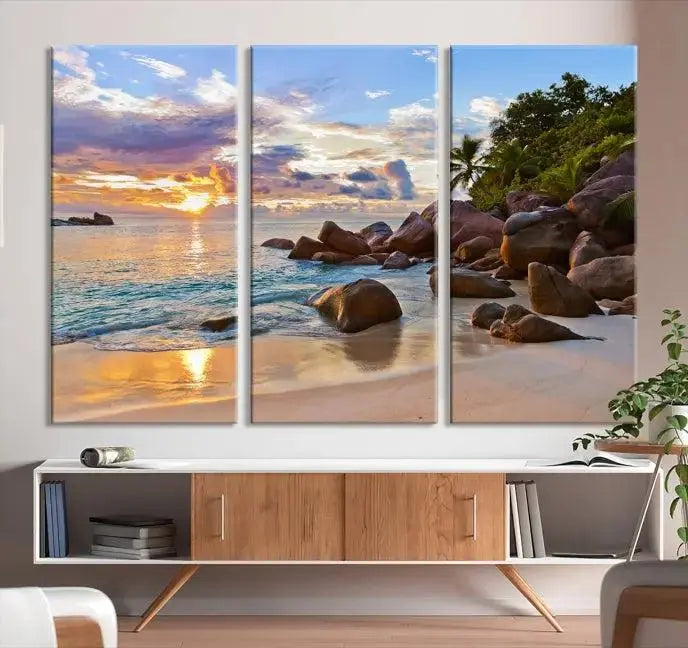 In a cozy living room, the "Tropical Island Beach Sunset Canvas Print," crafted on museum-quality canvas, hangs on the wall.