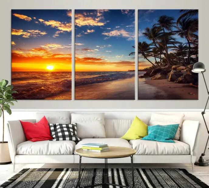 A living room featuring the Tropical Island Wall Art Canvas Print Sunset Artwork Print, a triptych displaying a beach sunset on museum-quality canvas with UV-protective coating, is prepared to hang.