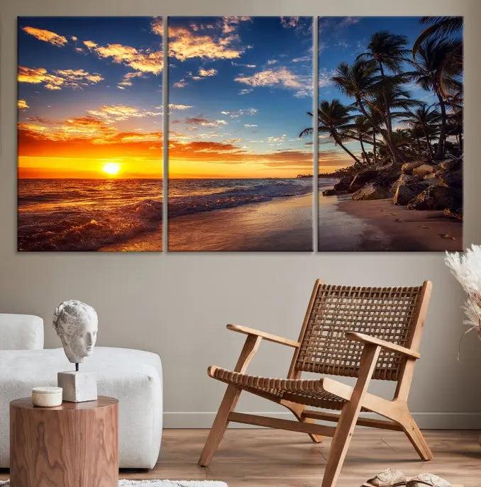 A living room featuring the Tropical Island Wall Art Canvas Print Sunset Artwork Print, a triptych displaying a beach sunset on museum-quality canvas with UV-protective coating, is prepared to hang.