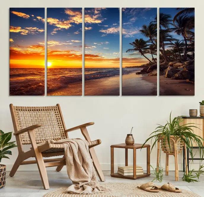 A living room featuring the Tropical Island Wall Art Canvas Print Sunset Artwork Print, a triptych displaying a beach sunset on museum-quality canvas with UV-protective coating, is prepared to hang.