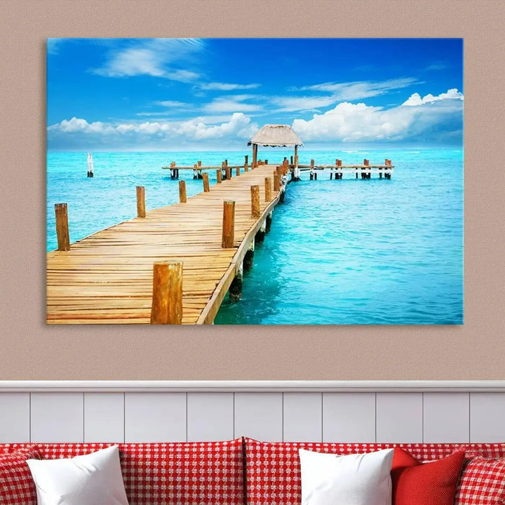 The Tropical Pier Triptych Wall Art is a captivating canvas print featuring a turquoise ocean and a wooden dock, ideal for coastal beach house decor.