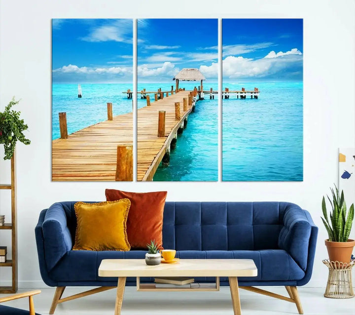 The Tropical Pier Triptych Wall Art is a captivating canvas print featuring a turquoise ocean and a wooden dock, ideal for coastal beach house decor.