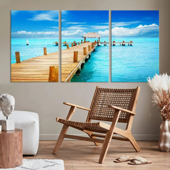 The Tropical Pier Triptych Wall Art is a captivating canvas print featuring a turquoise ocean and a wooden dock, ideal for coastal beach house decor.