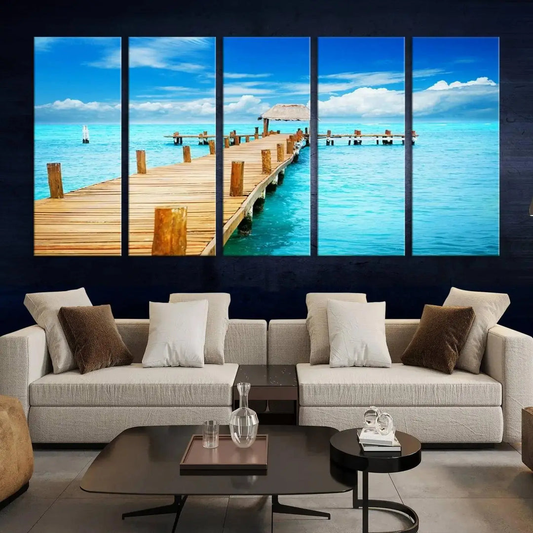 The Tropical Pier Triptych Wall Art is a captivating canvas print featuring a turquoise ocean and a wooden dock, ideal for coastal beach house decor.