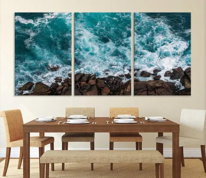 The Turquoise Aerial Wall Art Canvas Print, featuring a triptych of ocean waves crashing on rocks and printed on museum-quality canvas with a UV-protective coating, adds an exquisite touch to your living space. The gallery-wrapped pieces create a striking visual display.