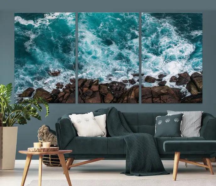 The Turquoise Aerial Wall Art Canvas Print, featuring a triptych of ocean waves crashing on rocks and printed on museum-quality canvas with a UV-protective coating, adds an exquisite touch to your living space. The gallery-wrapped pieces create a striking visual display.