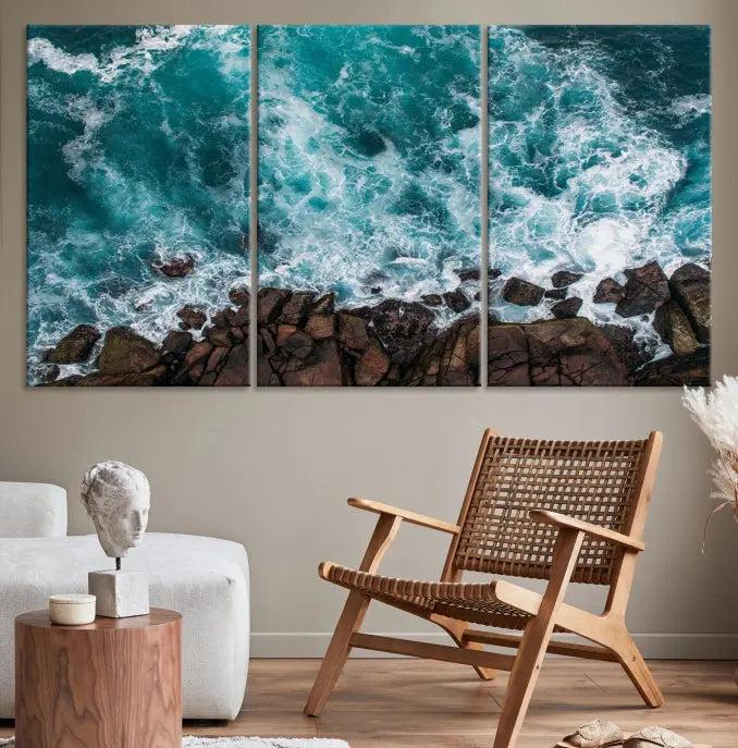 The Turquoise Aerial Wall Art Canvas Print, featuring a triptych of ocean waves crashing on rocks and printed on museum-quality canvas with a UV-protective coating, adds an exquisite touch to your living space. The gallery-wrapped pieces create a striking visual display.