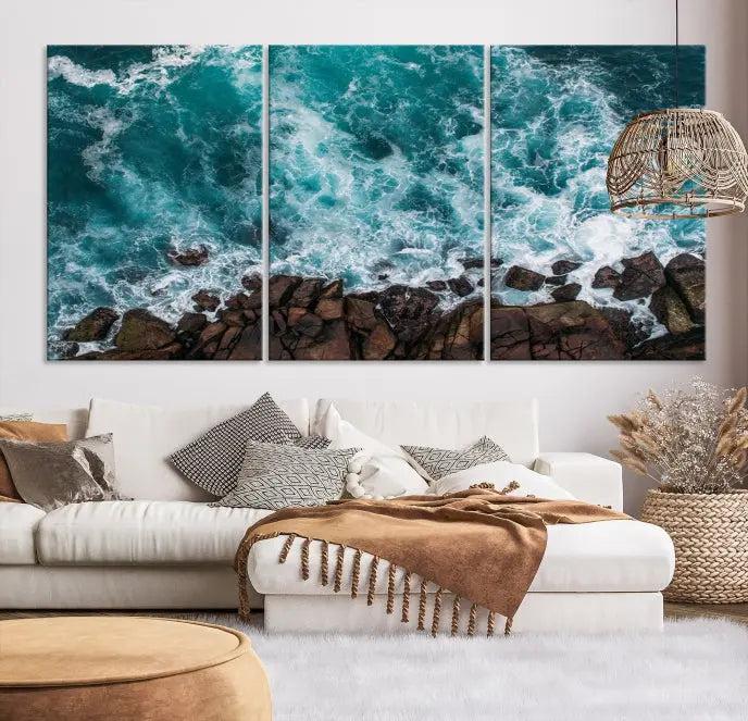 The Turquoise Aerial Wall Art Canvas Print, featuring a triptych of ocean waves crashing on rocks and printed on museum-quality canvas with a UV-protective coating, adds an exquisite touch to your living space. The gallery-wrapped pieces create a striking visual display.