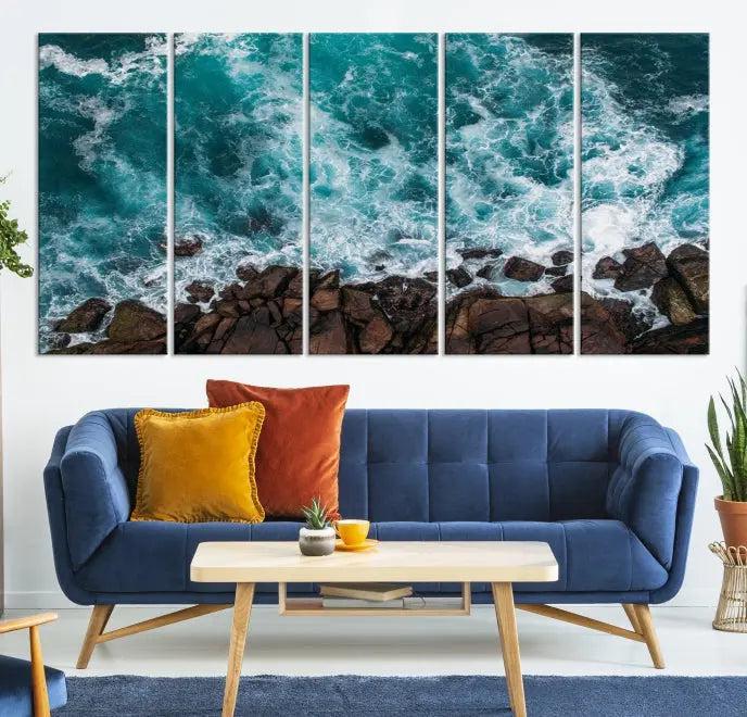 The Turquoise Aerial Wall Art Canvas Print, featuring a triptych of ocean waves crashing on rocks and printed on museum-quality canvas with a UV-protective coating, adds an exquisite touch to your living space. The gallery-wrapped pieces create a striking visual display.