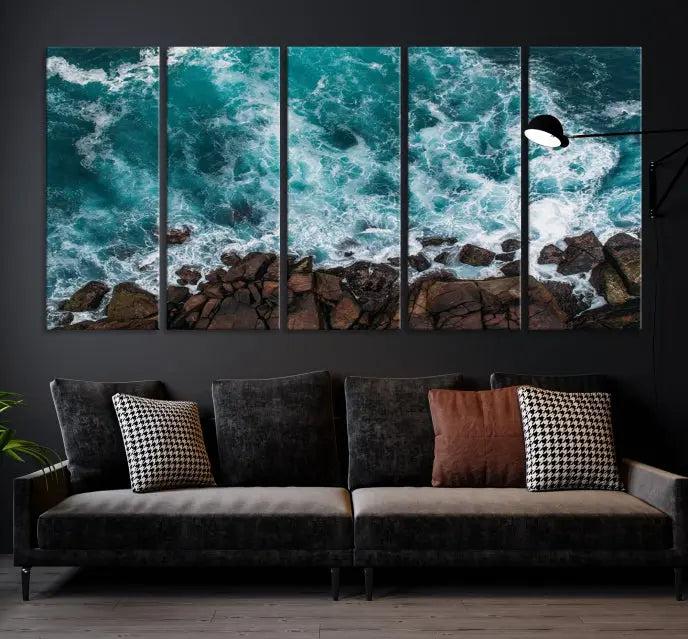 The Turquoise Aerial Wall Art Canvas Print, featuring a triptych of ocean waves crashing on rocks and printed on museum-quality canvas with a UV-protective coating, adds an exquisite touch to your living space. The gallery-wrapped pieces create a striking visual display.