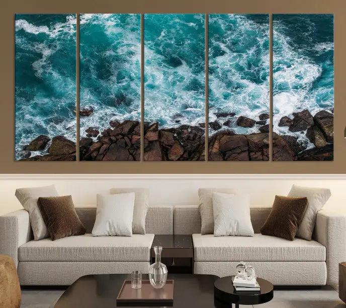 The Turquoise Aerial Wall Art Canvas Print, featuring a triptych of ocean waves crashing on rocks and printed on museum-quality canvas with a UV-protective coating, adds an exquisite touch to your living space. The gallery-wrapped pieces create a striking visual display.