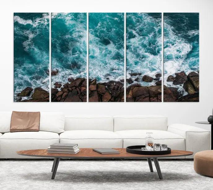 The Turquoise Aerial Wall Art Canvas Print, featuring a triptych of ocean waves crashing on rocks and printed on museum-quality canvas with a UV-protective coating, adds an exquisite touch to your living space. The gallery-wrapped pieces create a striking visual display.