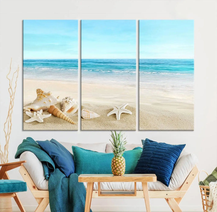 The "Turquoise Ocean View Seashell Starfish on the Beach Canvas Print Artwork" is a triptych piece that showcases a tranquil beach scene, complete with seashells and starfish adorning the sand. It is elegantly gallery-wrapped on museum-quality canvas.