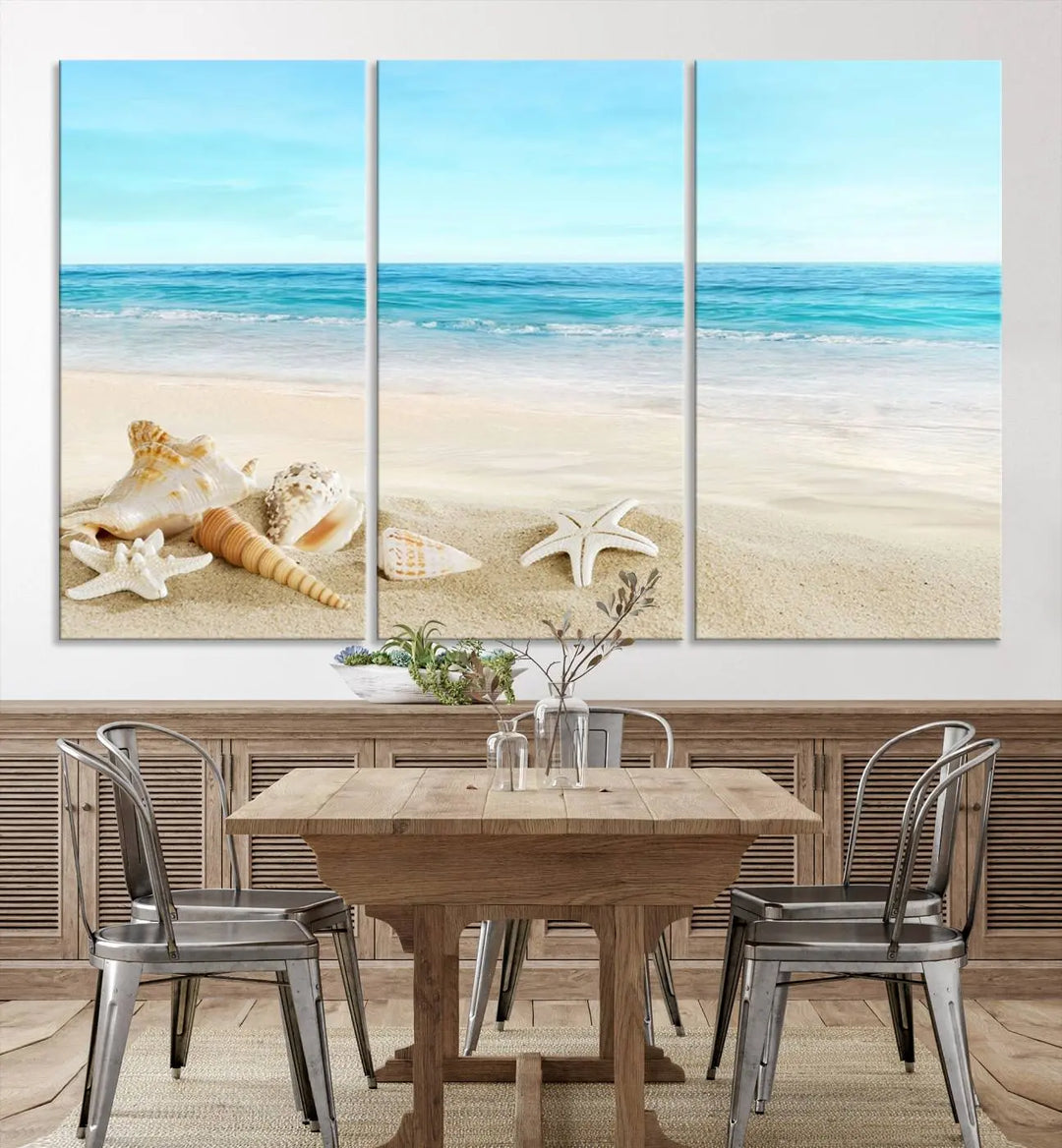 The "Turquoise Ocean View Seashell Starfish on the Beach Canvas Print Artwork" is a triptych piece that showcases a tranquil beach scene, complete with seashells and starfish adorning the sand. It is elegantly gallery-wrapped on museum-quality canvas.