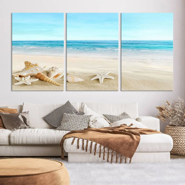 The "Turquoise Ocean View Seashell Starfish on the Beach Canvas Print Artwork" is a triptych piece that showcases a tranquil beach scene, complete with seashells and starfish adorning the sand. It is elegantly gallery-wrapped on museum-quality canvas.