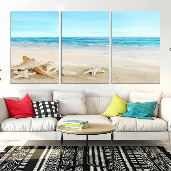 The "Turquoise Ocean View Seashell Starfish on the Beach Canvas Print Artwork" is a triptych piece that showcases a tranquil beach scene, complete with seashells and starfish adorning the sand. It is elegantly gallery-wrapped on museum-quality canvas.