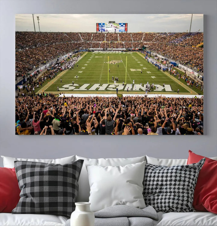 The living room features premium artwork, the "UCF Knights Football Team Print - Orlando FBC Mortgage Stadium Wall Art Canvas Print," a three-panel canvas piece depicting a bustling football stadium. Handmade in the USA, this artwork adds a dynamic and vibrant touch to your space.