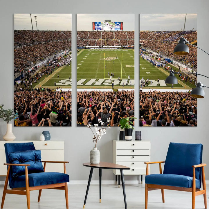 The living room features premium artwork, the "UCF Knights Football Team Print - Orlando FBC Mortgage Stadium Wall Art Canvas Print," a three-panel canvas piece depicting a bustling football stadium. Handmade in the USA, this artwork adds a dynamic and vibrant touch to your space.