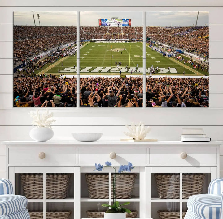 The living room features premium artwork, the "UCF Knights Football Team Print - Orlando FBC Mortgage Stadium Wall Art Canvas Print," a three-panel canvas piece depicting a bustling football stadium. Handmade in the USA, this artwork adds a dynamic and vibrant touch to your space.