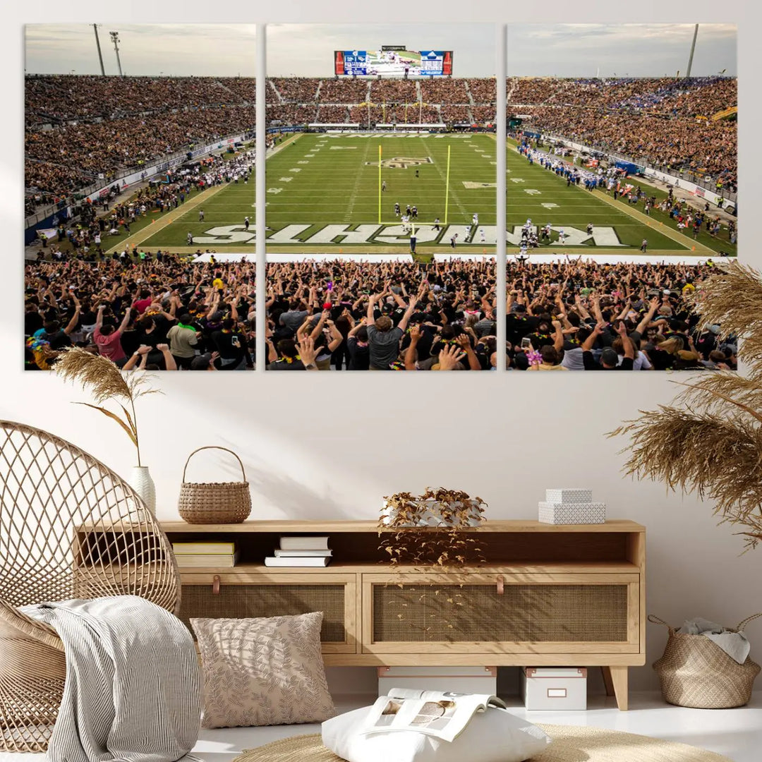 The living room features premium artwork, the "UCF Knights Football Team Print - Orlando FBC Mortgage Stadium Wall Art Canvas Print," a three-panel canvas piece depicting a bustling football stadium. Handmade in the USA, this artwork adds a dynamic and vibrant touch to your space.