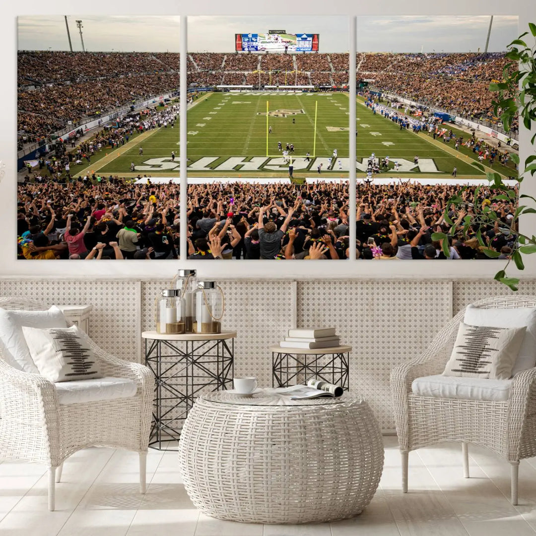 The living room features premium artwork, the "UCF Knights Football Team Print - Orlando FBC Mortgage Stadium Wall Art Canvas Print," a three-panel canvas piece depicting a bustling football stadium. Handmade in the USA, this artwork adds a dynamic and vibrant touch to your space.