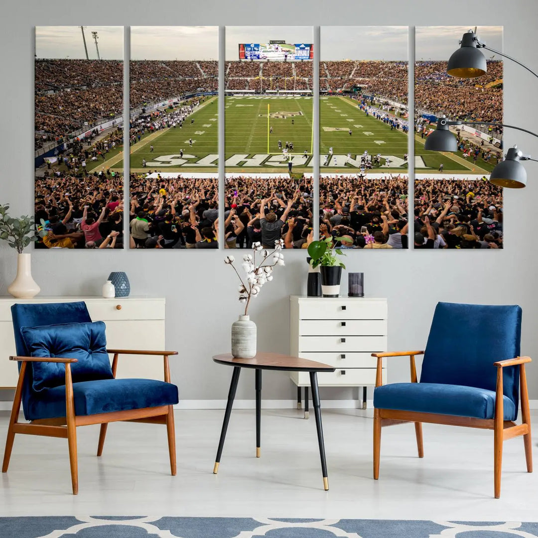 The living room features premium artwork, the "UCF Knights Football Team Print - Orlando FBC Mortgage Stadium Wall Art Canvas Print," a three-panel canvas piece depicting a bustling football stadium. Handmade in the USA, this artwork adds a dynamic and vibrant touch to your space.