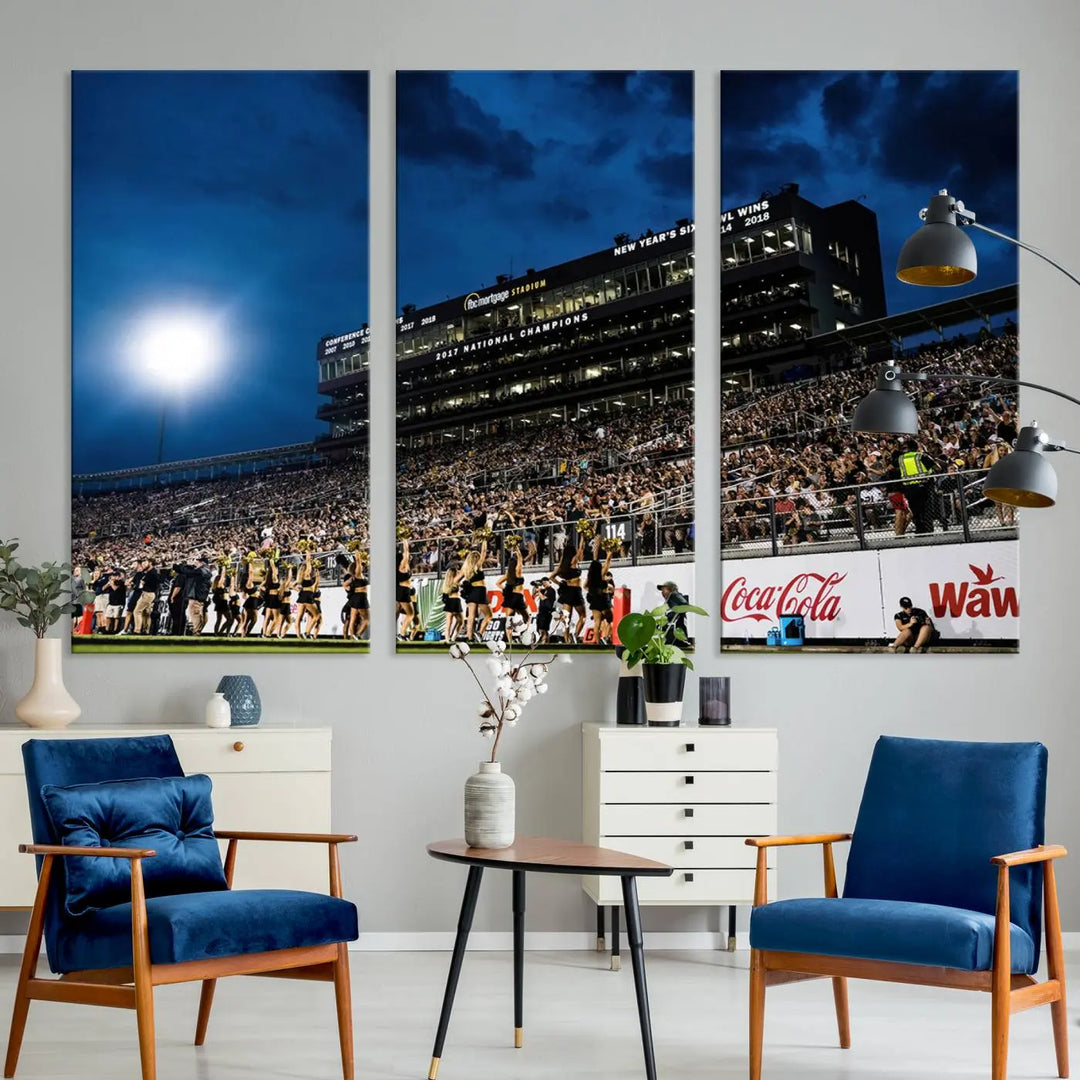 A stunning UCF Knights Football Team print is displayed, capturing the excitement of a night game at the Orlando FBC Mortgage Stadium in front of a lively crowd. This premium canvas offers a gallery-quality finish that brings the scene to life.