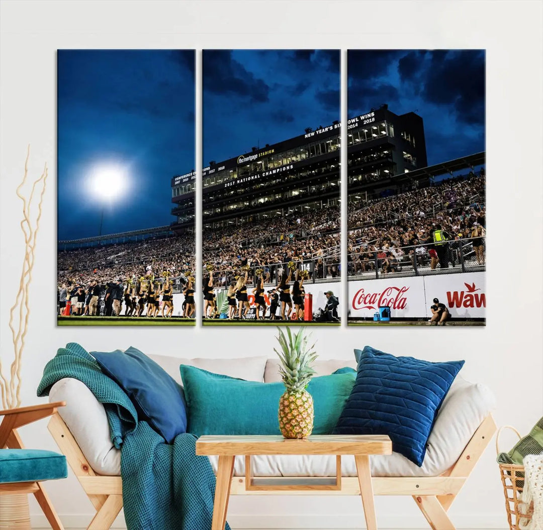 A stunning UCF Knights Football Team print is displayed, capturing the excitement of a night game at the Orlando FBC Mortgage Stadium in front of a lively crowd. This premium canvas offers a gallery-quality finish that brings the scene to life.