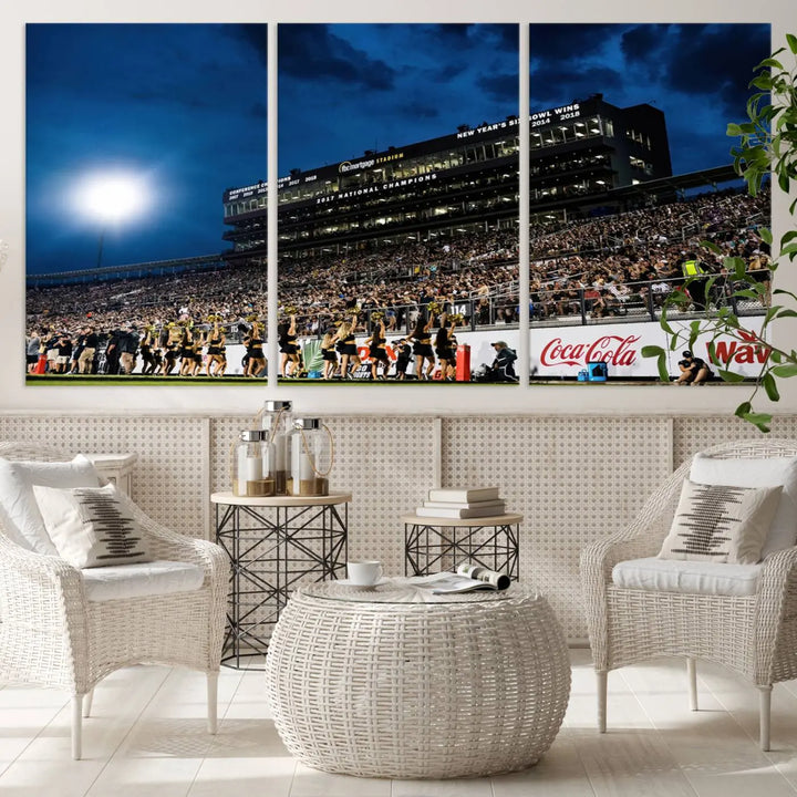 A stunning UCF Knights Football Team print is displayed, capturing the excitement of a night game at the Orlando FBC Mortgage Stadium in front of a lively crowd. This premium canvas offers a gallery-quality finish that brings the scene to life.