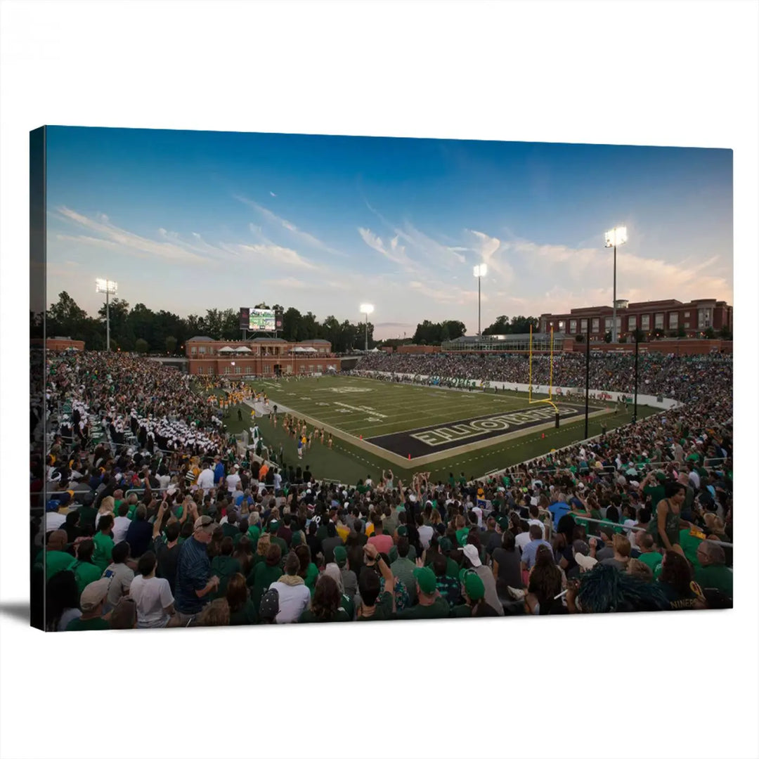 Above the dining table hangs a premium canvas triptych depicting Charlotte Jerry Richardson Stadium, home of the University of Charlotte 49ers Football Team. The scene is alive with a nighttime atmosphere, bustling with a large crowd under bright stadium lights. This stunning art piece is expertly handmade in the USA and adds vibrant energy to your living space.