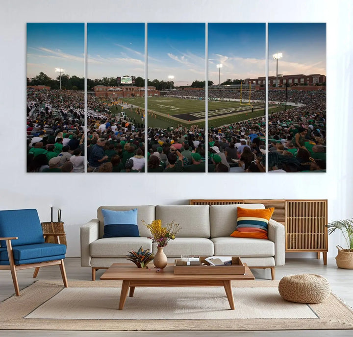 Above the dining table hangs a premium canvas triptych depicting Charlotte Jerry Richardson Stadium, home of the University of Charlotte 49ers Football Team. The scene is alive with a nighttime atmosphere, bustling with a large crowd under bright stadium lights. This stunning art piece is expertly handmade in the USA and adds vibrant energy to your living space.