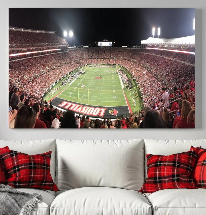 A canvas print featuring the University of Louisville Cardinals Football Team and a bustling Cardinal Stadium at night adorns the wall.