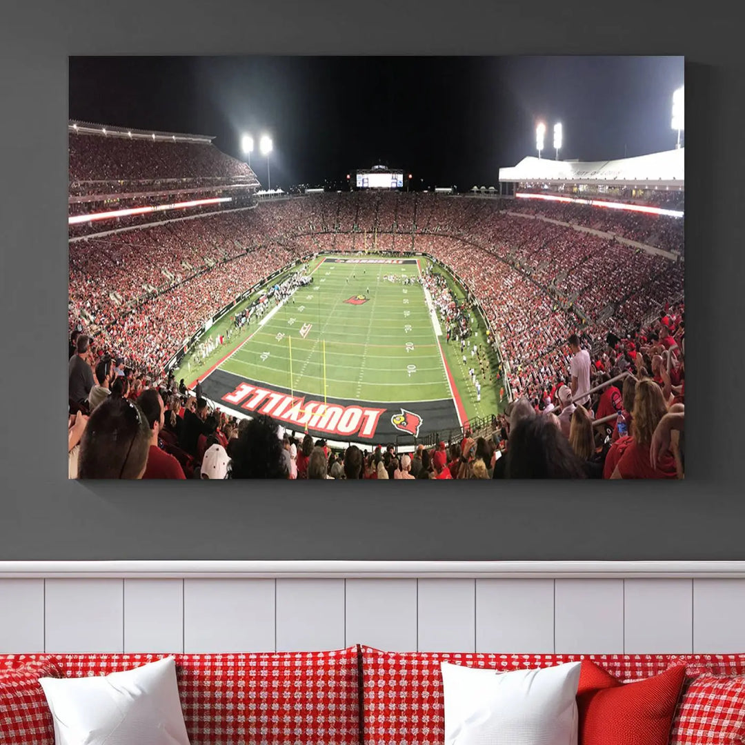 A canvas print featuring the University of Louisville Cardinals Football Team and a bustling Cardinal Stadium at night adorns the wall.