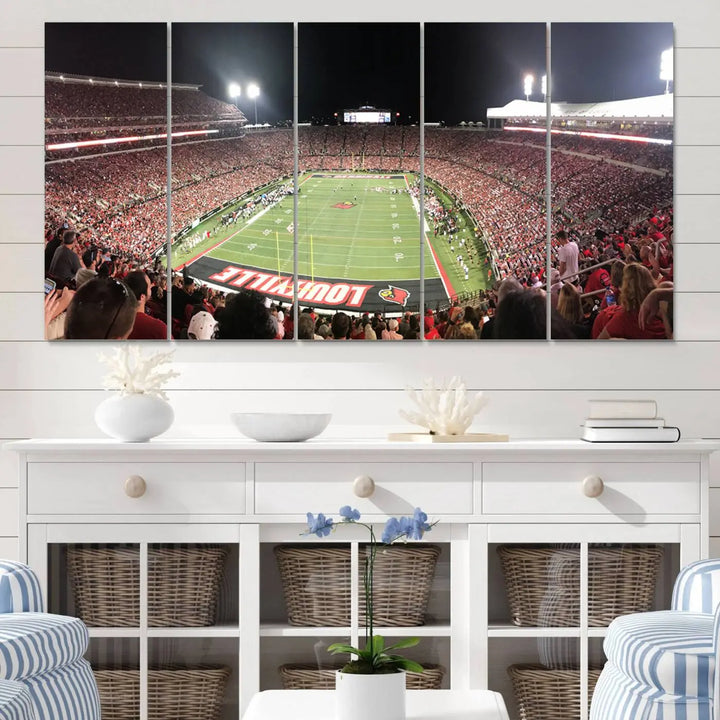 A canvas print featuring the University of Louisville Cardinals Football Team and a bustling Cardinal Stadium at night adorns the wall.