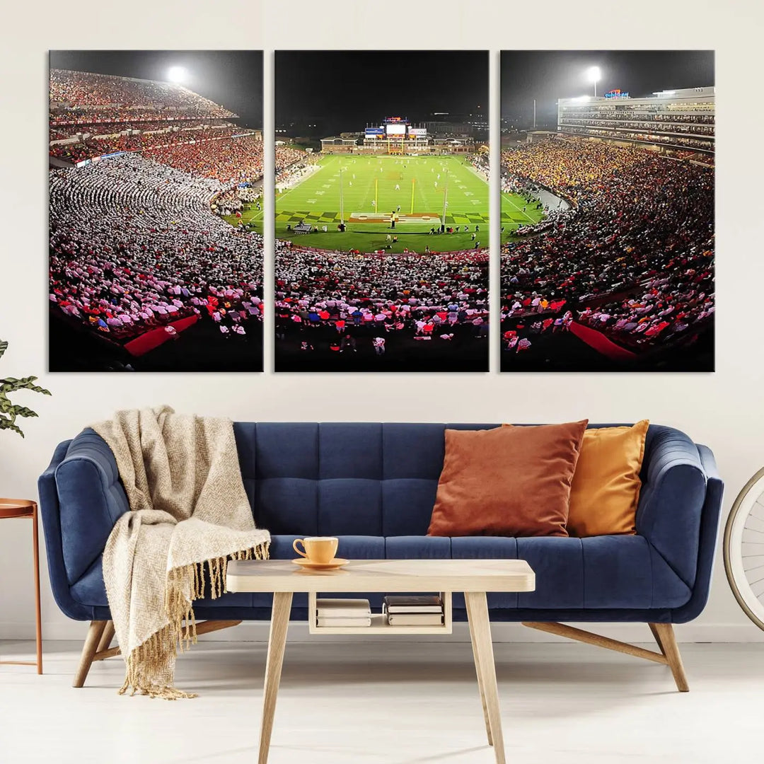 A University of Maryland Terrapins Football Team Print, featuring the College Park SECU Stadium at night, printed on premium canvas with a gallery-quality finish, enhances a modern living room.