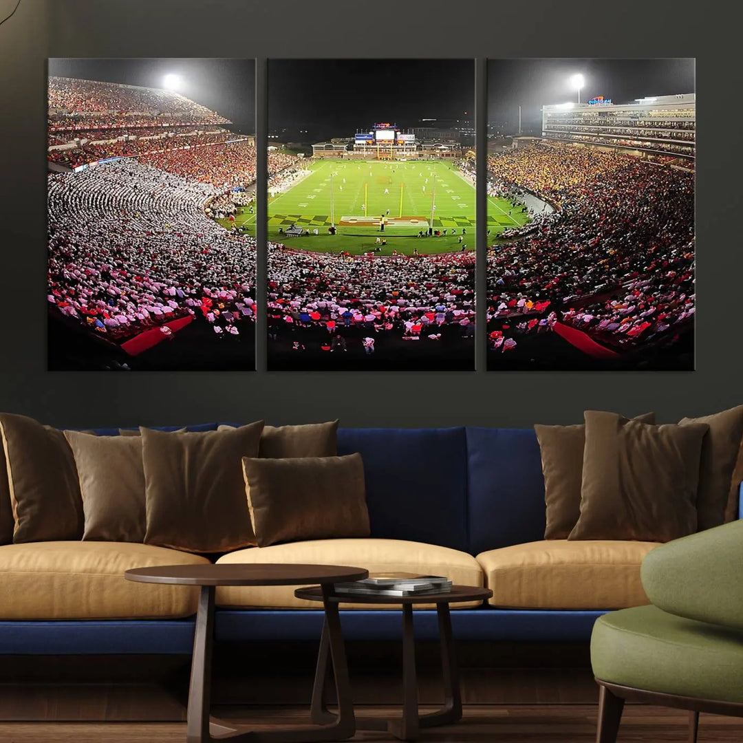 A University of Maryland Terrapins Football Team Print, featuring the College Park SECU Stadium at night, printed on premium canvas with a gallery-quality finish, enhances a modern living room.