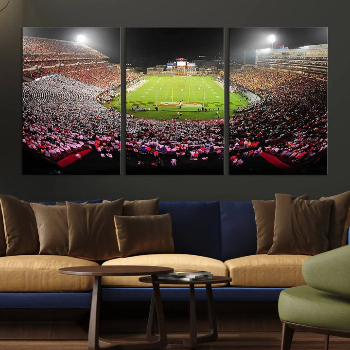 A University of Maryland Terrapins Football Team Print, featuring the College Park SECU Stadium at night, printed on premium canvas with a gallery-quality finish, enhances a modern living room.