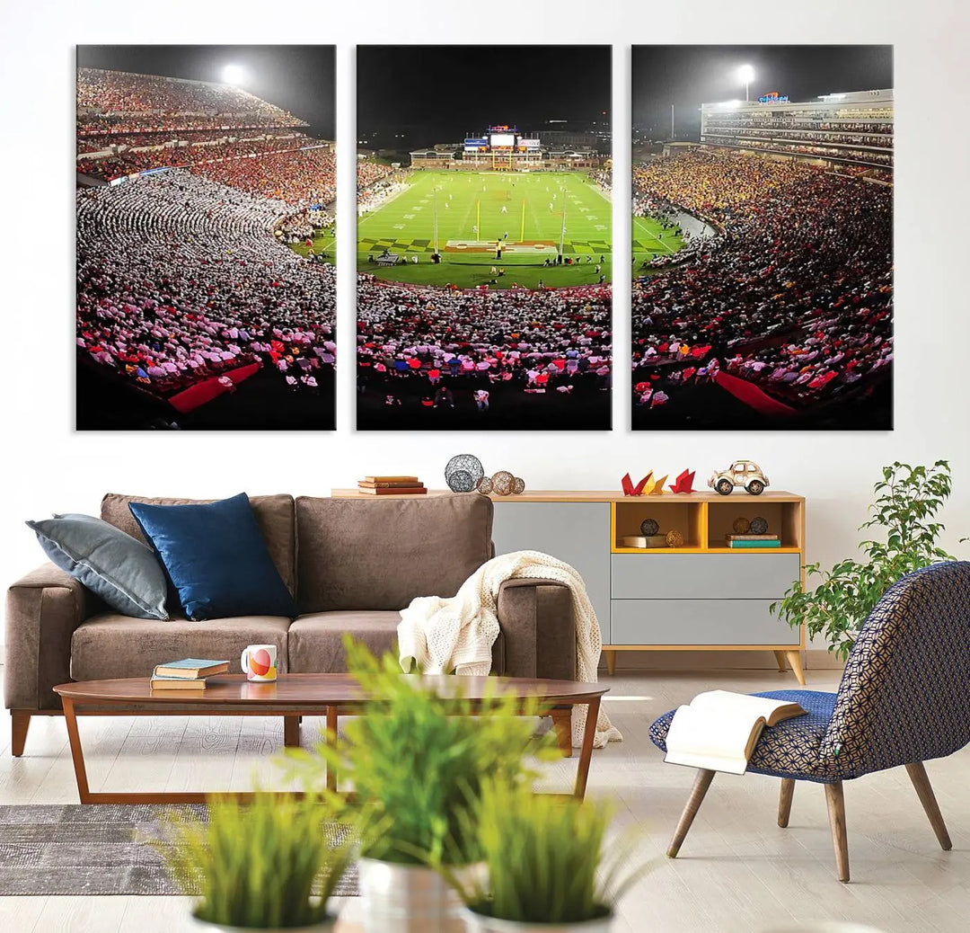 A University of Maryland Terrapins Football Team Print, featuring the College Park SECU Stadium at night, printed on premium canvas with a gallery-quality finish, enhances a modern living room.