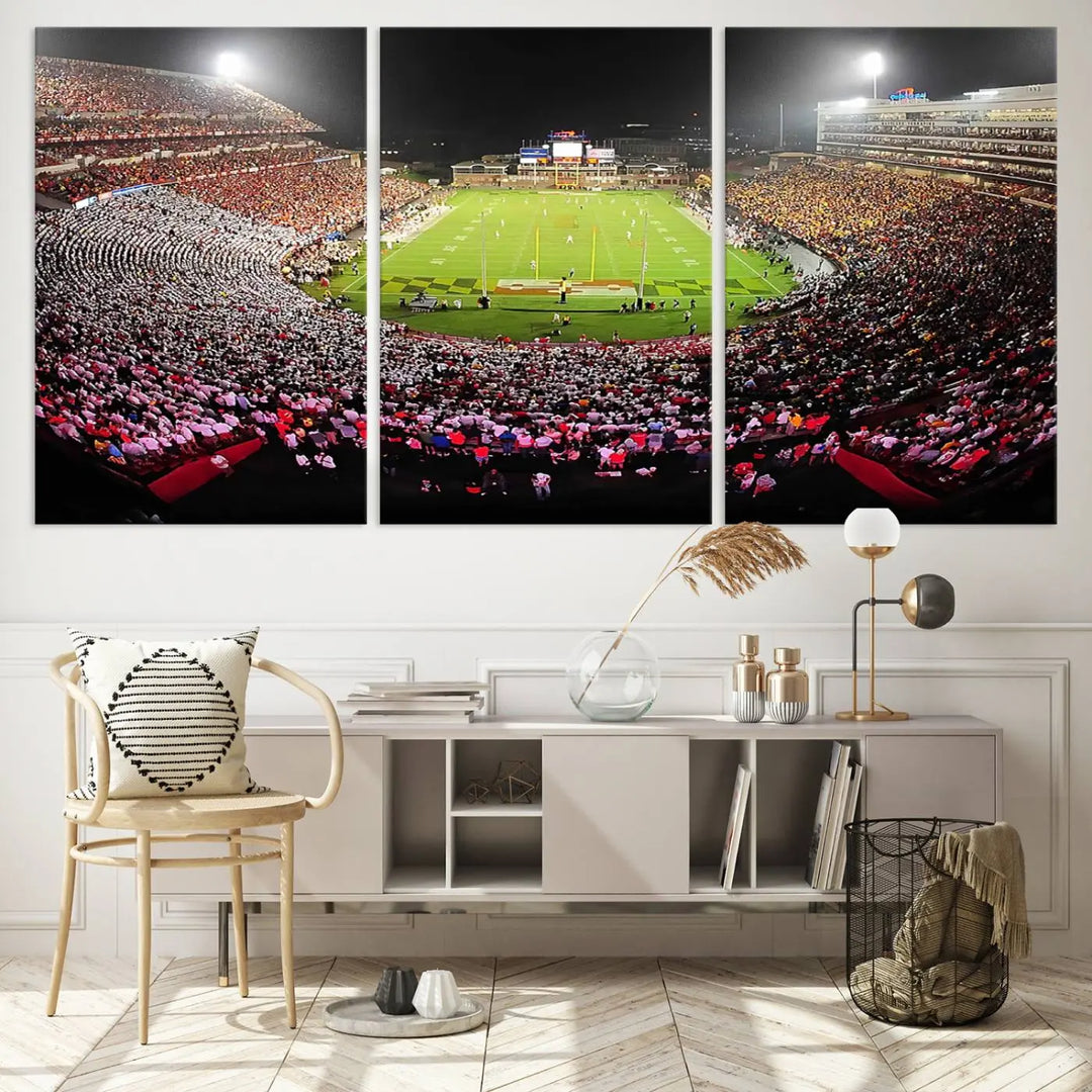 A University of Maryland Terrapins Football Team Print, featuring the College Park SECU Stadium at night, printed on premium canvas with a gallery-quality finish, enhances a modern living room.