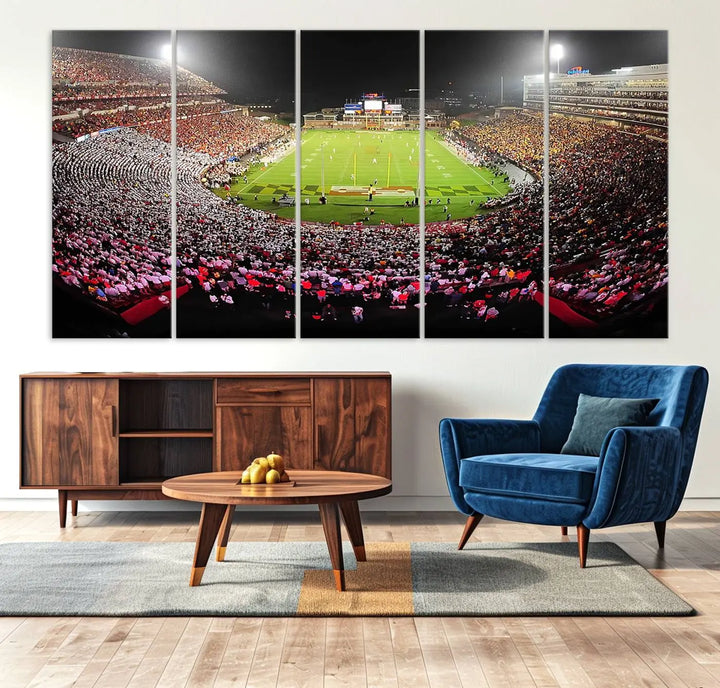 A University of Maryland Terrapins Football Team Print, featuring the College Park SECU Stadium at night, printed on premium canvas with a gallery-quality finish, enhances a modern living room.